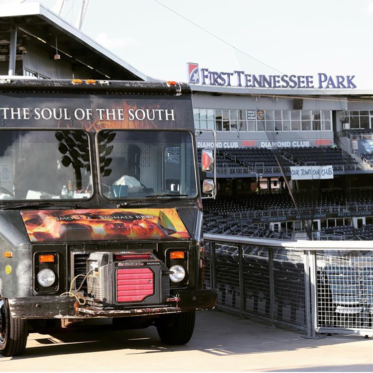 The Smoqe Signals BBQ food truck parked outside First Tennessee Park in Nashville
